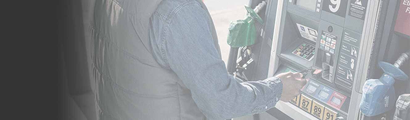 Man inserting card into fuel pump.