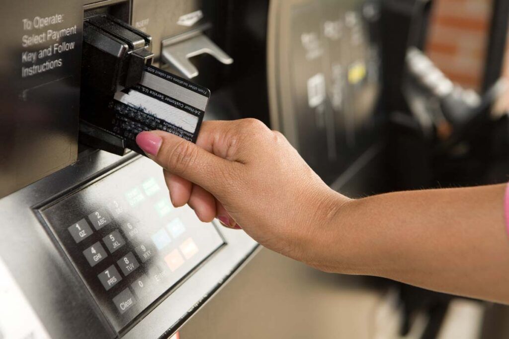 Hand inserting payment card.