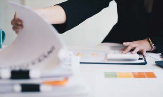 Woman reviewing documents at a desk.
