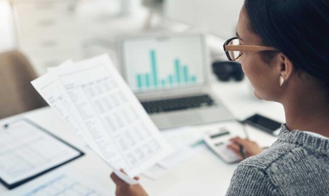 Professional reviewing fleet card benefits when reviewing fleet expenses.