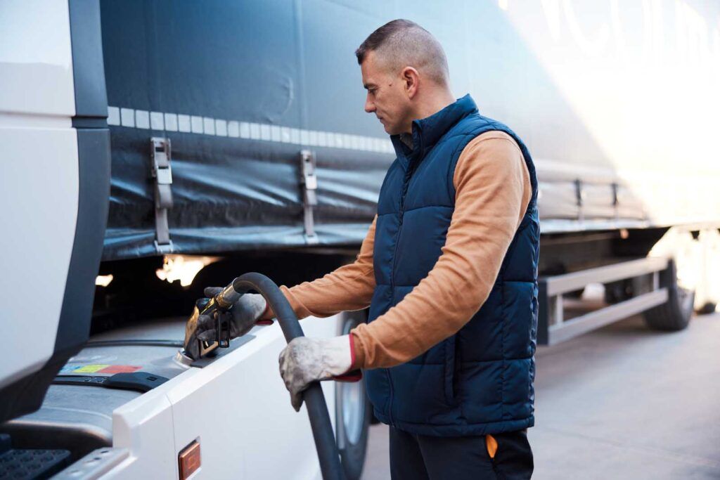 Driver at a fuel station using a fuel gas card as an efficient way to log expenses.