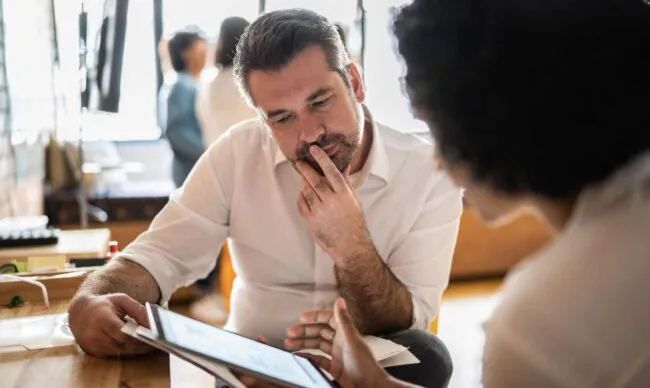 Business managers reviewing the company's fuel spending policy.