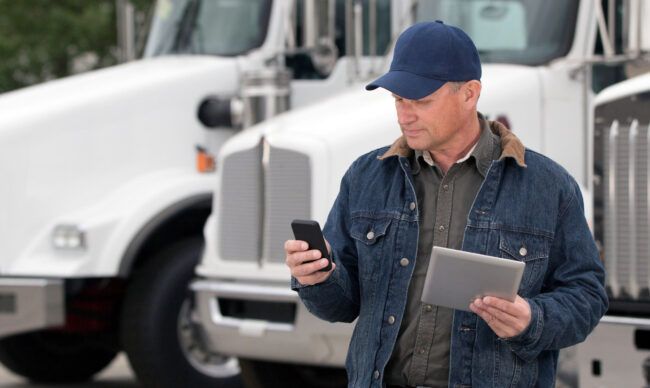 Supervisor learning how to manage fleet vehicles using tech solutions.