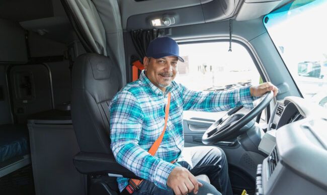 Operator driving a vehicle equipped with fleet management tools.