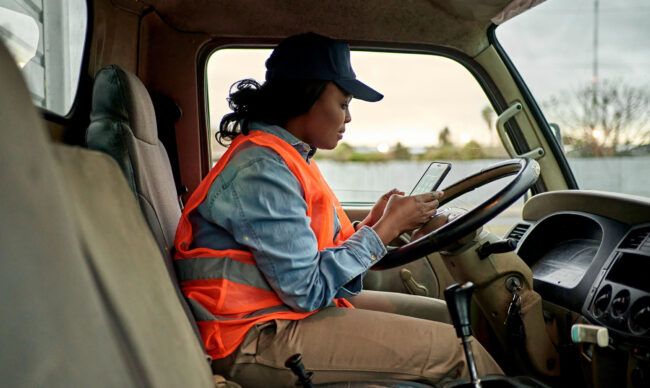 Operator reviewing fleet card security information during a fuel stop.