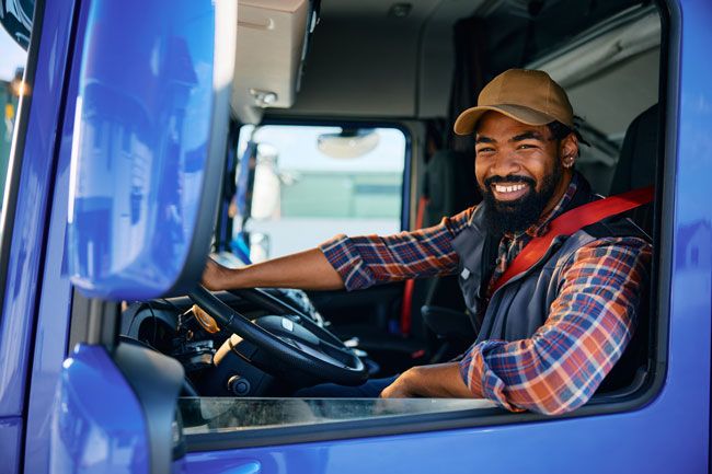 Driver appreciating the convenience and enhanced security of using a fleet fuel card.
