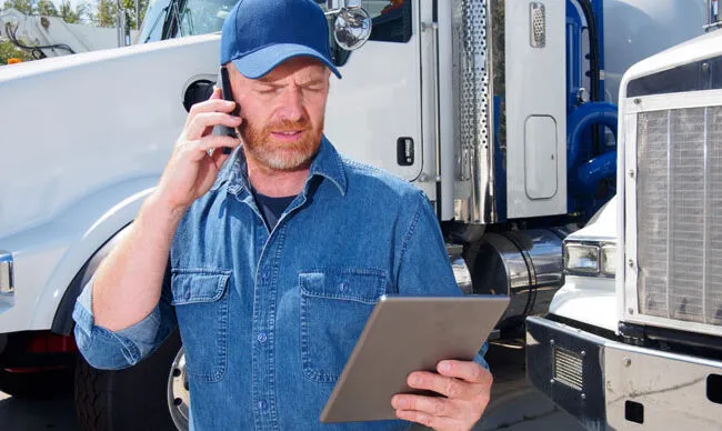 Manager reviewing fleet card information to streamline operations.