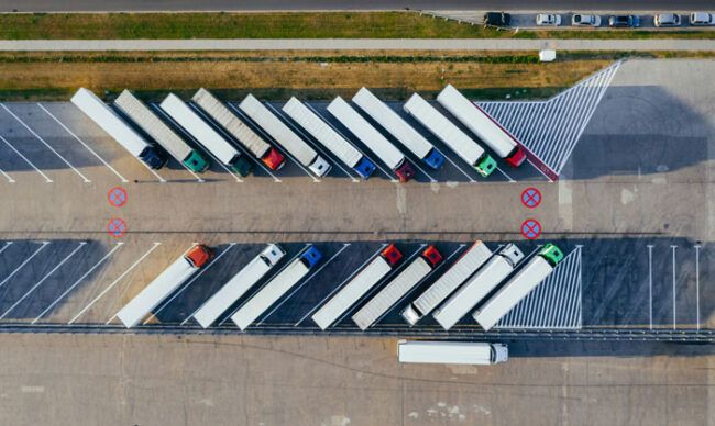 An overhead view of a fleet of semi trucks.