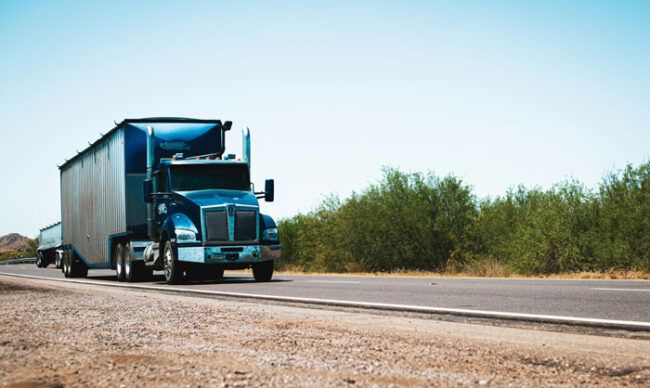 View of a semi truck driving along its route.