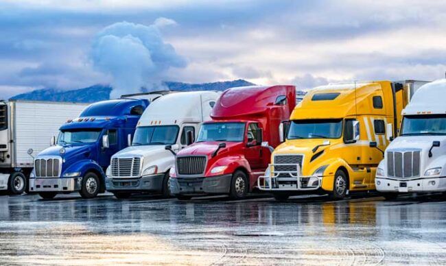 A fleet of semi trucks prepare to run their routes.