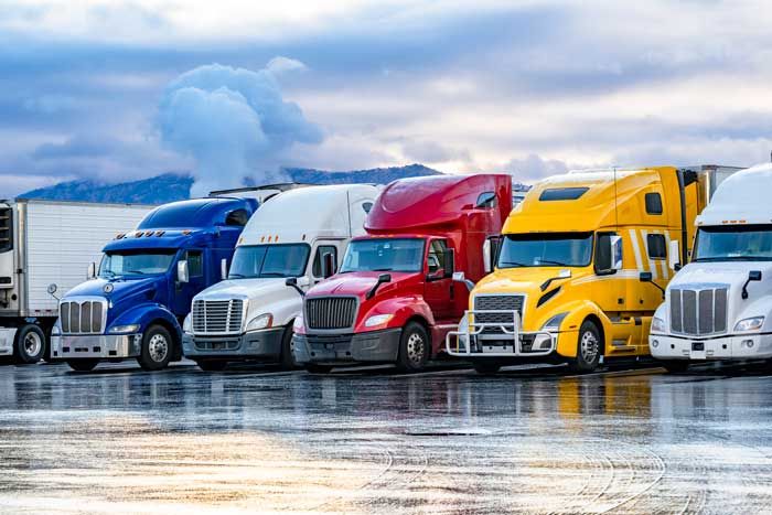 A fleet of semi trucks prepare to run their routes.